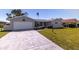 Charming single-story home with a well-maintained lawn and attached garage at 7307 14Th W Ave, Bradenton, FL 34209