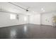 Large empty garage with tile floor, white walls, and a back door at 7307 14Th W Ave, Bradenton, FL 34209