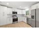 Clean kitchen showcases white cabinets, stainless steel appliances, and light wood flooring at 7307 14Th W Ave, Bradenton, FL 34209