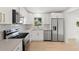 Well-lit kitchen features stainless steel appliances, white cabinetry and tiled backsplash at 7307 14Th W Ave, Bradenton, FL 34209