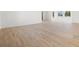 Spacious living room with wood-look tile flooring and views to other rooms and the exterior at 7307 14Th W Ave, Bradenton, FL 34209