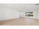 Bright living room with wood-look tile flooring, modern windows and a white painted walls at 7307 14Th W Ave, Bradenton, FL 34209