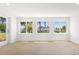 Living room features wood-look tile flooring and large windows for plenty of natural light at 7307 14Th W Ave, Bradenton, FL 34209
