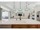 Kitchen island featuring stainless steel appliances, a sink and view of the living room at 7324 Riviera Cv, Lakewood Ranch, FL 34202