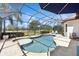 Screened-in pool featuring a spa and a view of the golf course at 7324 Riviera Cv, Lakewood Ranch, FL 34202