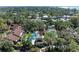 An aerial view showcases the pool and tennis courts amidst mature trees, offering recreational amenities and neighborhood charm at 7615 4Th W Ave # 7615, Bradenton, FL 34209