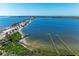 An aerial shot shows a long bridge crossing the tranquil blue water with docks extending into the sea at 7615 4Th W Ave # 7615, Bradenton, FL 34209
