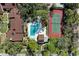 Aerial view features the community pool and tennis court, surrounded by lush landscaping and a relaxed, recreational atmosphere at 7615 4Th W Ave # 7615, Bradenton, FL 34209