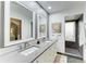 Modern bathroom with double sinks, quartz countertops, and a sleek walk-in shower at 7615 4Th W Ave # 7615, Bradenton, FL 34209
