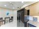 Kitchen area complemented by a black refrigerator and nearby table with seating at 7615 4Th W Ave # 7615, Bradenton, FL 34209