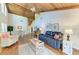 Open-concept living room boasts vaulted wood ceilings, hardwood floors, and comfortable furnishings at 7615 4Th W Ave # 7615, Bradenton, FL 34209