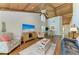 Bright and open living room with vaulted wood ceilings, hardwood floors, and an adjacent dining area at 7615 4Th W Ave # 7615, Bradenton, FL 34209