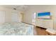 Comfortable bedroom featuring hardwood floors and a TV, leading to an attached bathroom at 7615 4Th W Ave # 7615, Bradenton, FL 34209