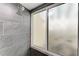Contemporary shower with dark gray tiling and glass door, offering a modern spa-like experience at 7615 4Th W Ave # 7615, Bradenton, FL 34209