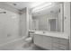 Bright bathroom featuring a vanity, bathtub, and shower at 7665 Bergamo Ave, Sarasota, FL 34238