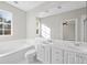 Bright bathroom with double vanity, bathtub, and natural light at 7665 Bergamo Ave, Sarasota, FL 34238