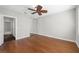 Bedroom featuring hardwood floors, a ceiling fan, and a large closet at 7665 Bergamo Ave, Sarasota, FL 34238