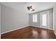 Clean and empty bedroom with hardwood floors and a back door leading to the outside at 7665 Bergamo Ave, Sarasota, FL 34238