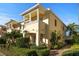 Elegant two-story home featuring a decorative balcony, lush landscaping, and a well-manicured walkway at 7665 Bergamo Ave, Sarasota, FL 34238