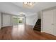 Spacious living room with hardwood floors, access to the patio, and a staircase to the upper level at 7665 Bergamo Ave, Sarasota, FL 34238