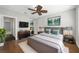 Comfortable main bedroom with hardwood floors, ceiling fan, and decor at 7665 Bergamo Ave, Sarasota, FL 34238