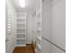 Bright walk-in closet with built-in shelving and hanging rods for optimal storage at 7665 Bergamo Ave, Sarasota, FL 34238