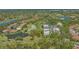 A beautiful aerial view featuring lush landscaping, a golf course, and several ponds surrounding the homes at 7782 Club Ln, Sarasota, FL 34238
