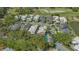 Aerial view of the community and home with a backyard pool and golf course in the background at 7782 Club Ln, Sarasota, FL 34238
