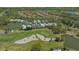 A stunning aerial view of the lush green golf course, several ponds, and the backs of a row of private homes at 7782 Club Ln, Sarasota, FL 34238