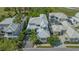 Aerial view of a modern white-roofed property with manicured landscaping and a private driveway at 7782 Club Ln, Sarasota, FL 34238