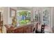 Custom wooden bar with views to tropical plants and outdoor terrace at 7782 Club Ln, Sarasota, FL 34238