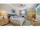 Comfortable bedroom with a ceiling fan and a window with exterior light at 7782 Club Ln, Sarasota, FL 34238