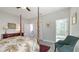 Spacious bedroom with wooden four poster bed, ceiling fan, and ensuite bathroom at 7782 Club Ln, Sarasota, FL 34238