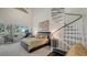 Bright bedroom features a spiral staircase and large windows with beautiful views at 7782 Club Ln, Sarasota, FL 34238