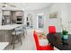 Bright eat-in kitchen boasts stainless appliances, a breakfast nook with red chairs, and island with bar seating at 7782 Club Ln, Sarasota, FL 34238
