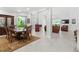 Spacious open-concept dining room flowing into the living room and adorned with an elegant table and chairs at 7782 Club Ln, Sarasota, FL 34238