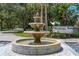 A tiered fountain sits in front of the community sign for 'The Enclave' at 7782 Club Ln, Sarasota, FL 34238