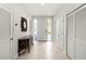 Bright foyer features tile flooring, white walls, and a decorative console table at 7782 Club Ln, Sarasota, FL 34238
