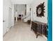 Bright foyer features tile flooring, white walls, and a decorative console table at 7782 Club Ln, Sarasota, FL 34238