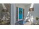 Inviting covered porch and bright blue door with wreath at 7782 Club Ln, Sarasota, FL 34238