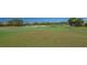 Picture of golf course with lush green grass and several sand traps on a sunny day at 7782 Club Ln, Sarasota, FL 34238