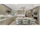 Spacious kitchen features stainless steel appliances, quartz countertops, and bar seating at the island at 7782 Club Ln, Sarasota, FL 34238