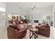 Spacious living room with high ceilings, white brick fireplace, and comfortable seating at 7782 Club Ln, Sarasota, FL 34238