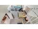 Aerial view of the bright main bedroom with stylish decor, natural light, and spiral staircase access at 7782 Club Ln, Sarasota, FL 34238