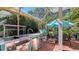 A well-equipped outdoor kitchen and dining area perfect for entertaining in a screened patio setting at 7782 Club Ln, Sarasota, FL 34238