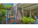 Enclosed outdoor space with view to covered lounge seating area on red flooring at 7782 Club Ln, Sarasota, FL 34238