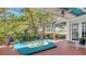 Serene spa on the screened lanai with golf course views and access to the outdoors at 7782 Club Ln, Sarasota, FL 34238