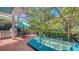 Outdoor living with a screened-in patio featuring a spa, patio furniture, and a built-in grill area at 7782 Club Ln, Sarasota, FL 34238