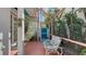 Cozy sitting area in a screened-in patio, surrounded by lush greenery and a tranquil garden view at 7782 Club Ln, Sarasota, FL 34238