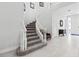 Elegant curved staircase with carpeted steps and white railing at 7782 Club Ln, Sarasota, FL 34238
